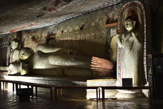 Buddha statues and murals in one of the cave temples of the Golden Temple