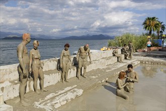 People taking a mud bath