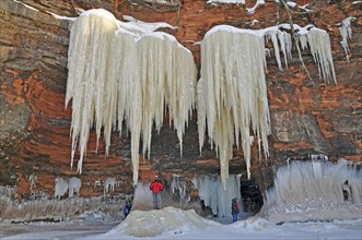 5 m long icicles hanging from red sandstone cliff