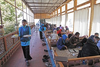 Young Iranians having lunch in a traditional restaurant