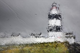 Hook Lighthouse through a rain-soaked pane of glass