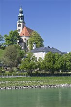The banks of the Salzach with the Mullner Kirche church