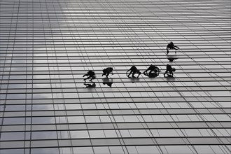 Window cleaners cleaning a glass facade