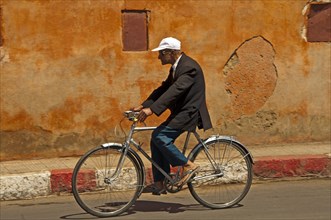 Elderly Moroccan riding a bicycle