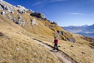 Mountain climber on the Dolomiten-Hohenweg mountain trail while ascending Peitlerkofel Mountain in Puez-Geisler Nature Park