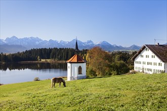 Chapel on Lake Hergratsried with Allgau Alps