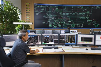 Shift supervisor Hans-Peter Polzer sitting at his work station in the Transmission Control Center