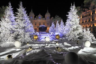 Christmas decorations with white fir trees on the square in front of the Monte Carlo Casino
