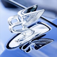 Hood ornament Flying B on a luxury vehicle of the British car manufacturer Bentley