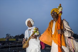 Two devotees with their music instruments at the banks of the holy river Godwari