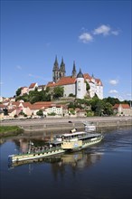 Paddle wheel steamer on the Elbe river in front of Albrecht Castle with the cathedral of Meissen