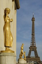 Golden statues at the Palais de Chaillot with the Eiffel Tower