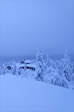 Finnish log cabin in the snow-covered landscape