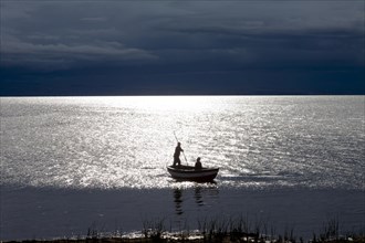 Two men in a small boat on Lake Titicaca