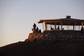 Tourists awaiting the sunrise on the summit of the Haleakala volcano