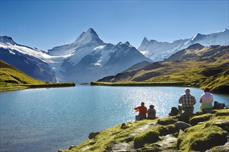 Walkers having a rest next to Bachalpsee lake near Grindelwald First