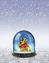 Easter bunny in a snow dome in snow