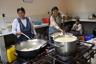 Cooks working in the kitchen of a boarding school