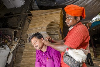 An ear cleaner at work at Mangaldas Market