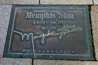 Plaque for the jazz musician Memphis Slim in the pavement of the 'Street of Fame'