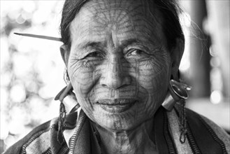 Woman with a traditional facial tattoo and ear jewelry