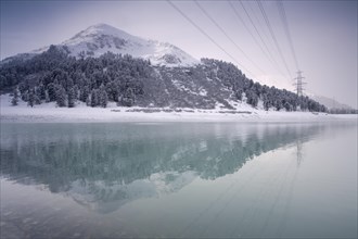 Laengental Reservoir with pylon in winter