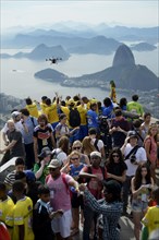 People cheering in the direction of a drone with cameras