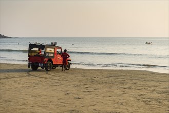 Live guards with a red jeep are watching Palolem Beach