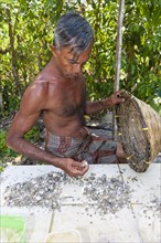 Labourer sorting moonstones from the sand