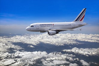 Air France Airbus A318-111 in flight over mountains
