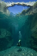 Scuba diver diving below the bridge of Ponte dei Salti
