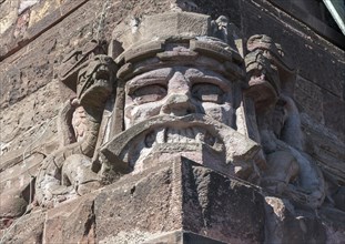 Snarling sandstone head mask and snakes