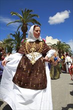 Young woman in traditional costume performing typical dance