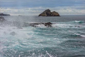 Waves breaking on the coast of Chinaman's Hat Island off Santiago Island