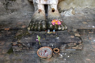 Feet of the standing Buddha statue Phra Attharot