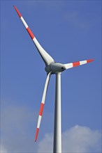 Wind turbine against blue sky