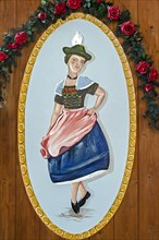 Woman dancing the Schuhplattler in Bavarian dress