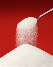 Sugar falling from a spoon