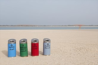 Rubbish bins for sorting waste on the beach at Corniche Road