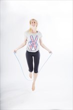 Woman in sportswear jumping rope