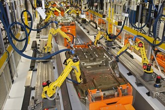 Robots at work in the underbody sealing and underbody coating station of the paint shop at Chrysler's Sterling Heights Assembly Plant
