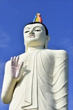 Large Buddha figure in front of a monastery near Sigiriya