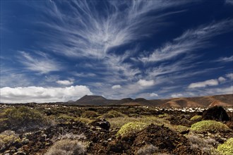 Cirrus clouds over volcanic landscape