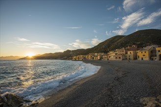 Typical houses on the beach at sunset