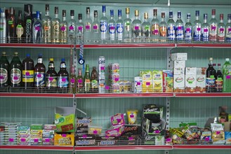 Alcoholic beverages and sweets on sale at a village market