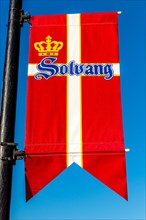 Flag of Denmark hanging on a lamppost in Solvang