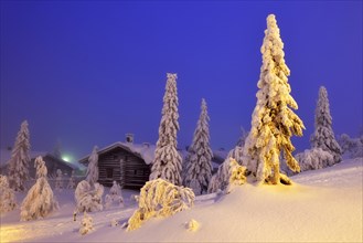 Finnish log cabin in the snow-covered landscape