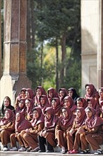 Iranian girls posing for a class photo wearing uniforms