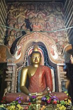 Large brightly painted golden Buddha figure