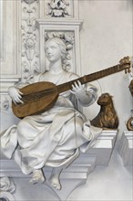 Female statue playing a stringed instrument